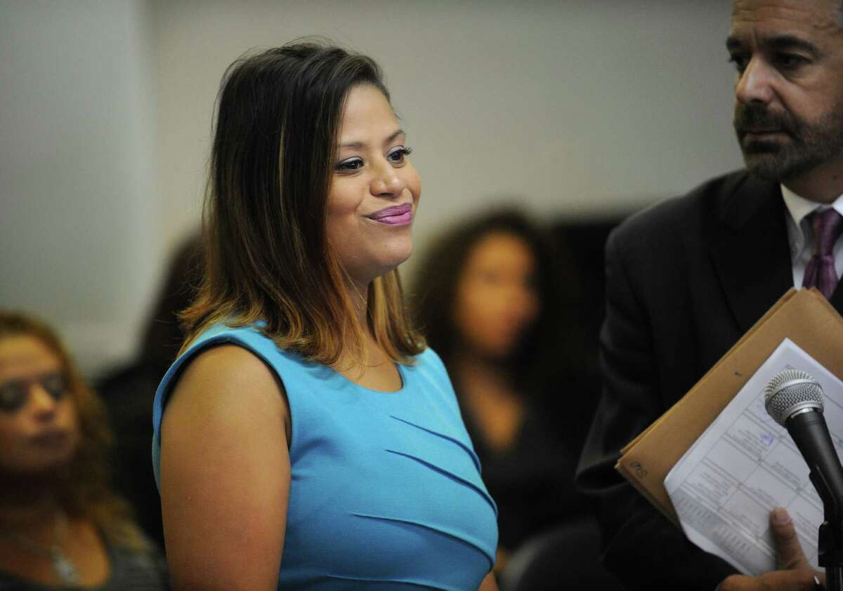 Bridgeport state representative candidate Christina Ayala smiles towards the judge as she and her attorney Guy Soares enter a not guilty plea in Superior Court in Bridgeport on Tuesday, Octber 16, 2012.