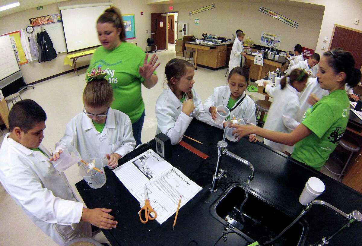 Students Dylan Farias (from left), Jolie Mead, Kaycee Mabe and Lauryn Brynelsen conduct experiments in water power with the help of teachers Vannessa Chandler and Tara Jacob (right).