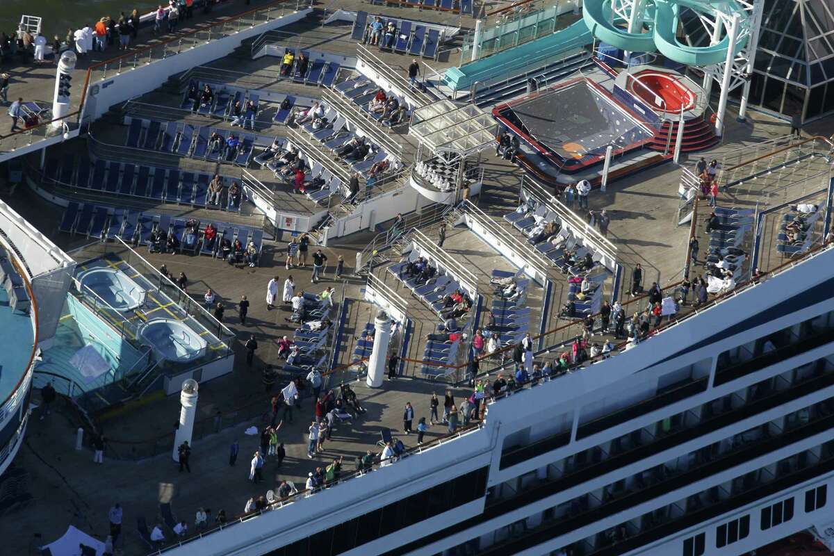 The disabled Carnival Lines cruise ship Triumph is towed to harbor off Mobile Bay, Ala., Thursday, Feb. 14, 2013. (AP Photo/Gerald Herbert)