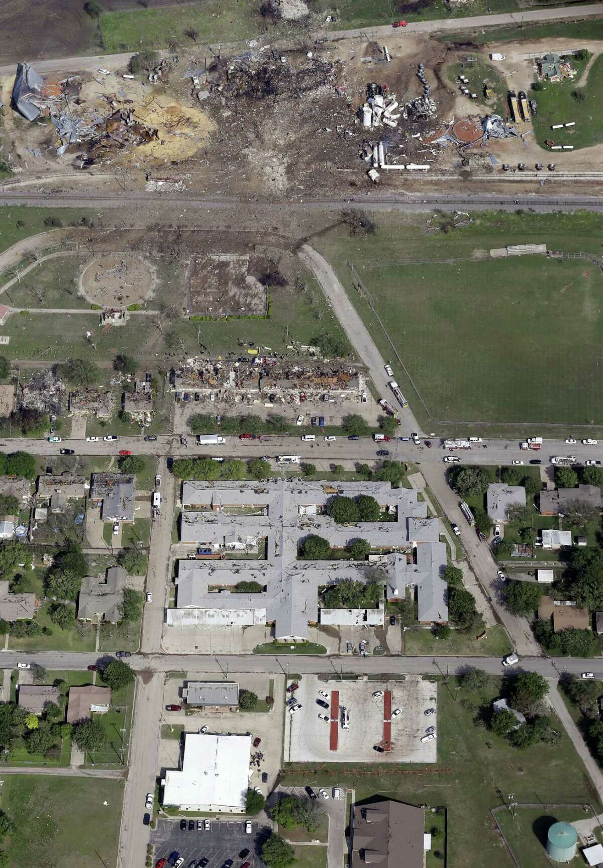 This April 18, 2013, aerial photo shows a destroyed West Fertilizer Co. plant, top, following an explosion in West, Texas. The Federal Emergency Management Agency is refusing to provide money to help rebuild West, the small Texas town where a deadly fertilizer plant explosion leveled numerous homes and a school, and killed 15 people. According to a letter obtained by The Associated Press, FEMA said it reviewed the state's appeal to help West but decided that the explosion "is not of the severity and magnitude that warrants a major disaster declaration." FEMA has, however, provided emergency funds to individual residents. (AP Photo/Tony Gutierrez)
