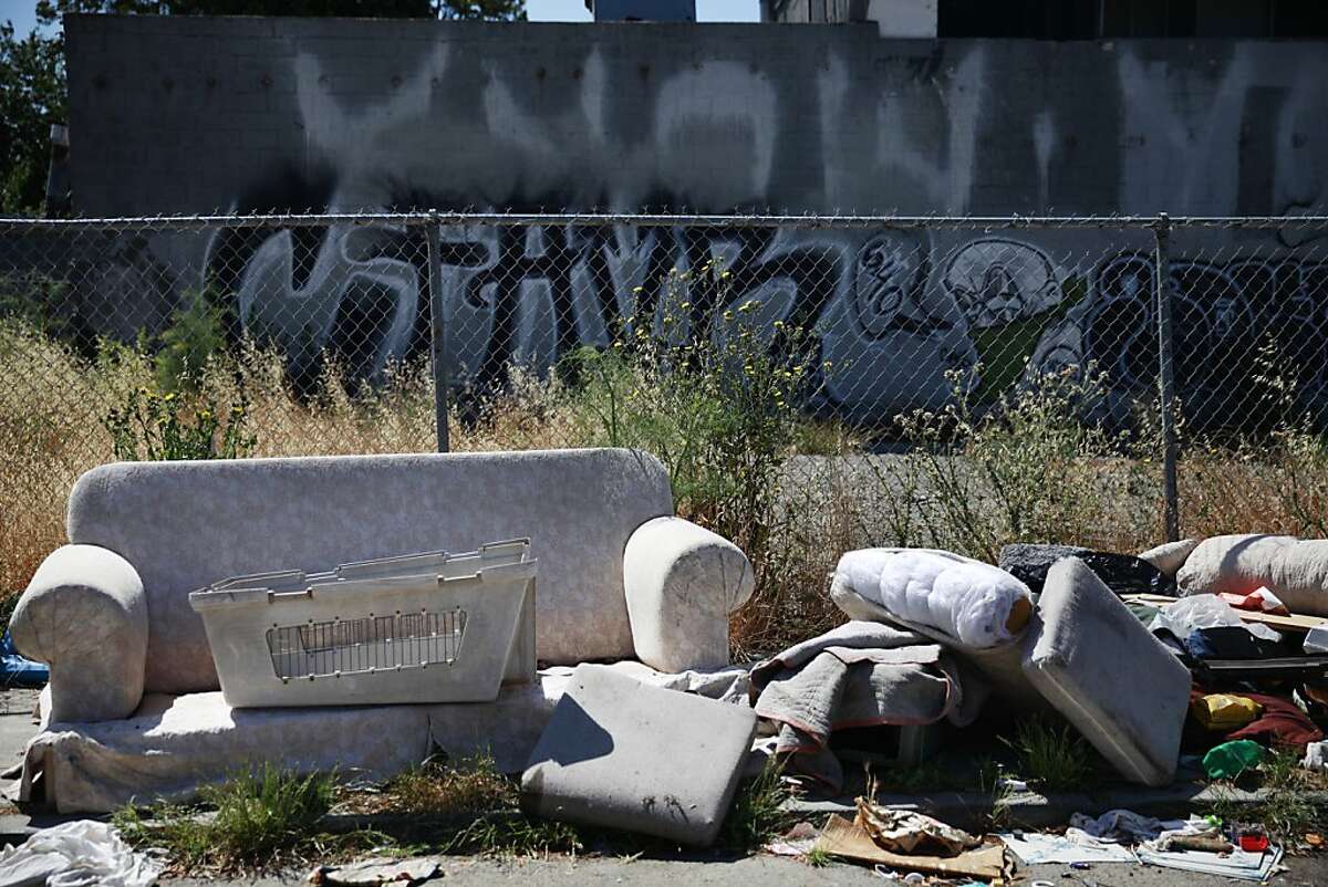 A sofa is seen along 71st Avenue near International Boulevard along with other garbage and debris on Wednesday, June 12, 2013 in Oakland, Calif.