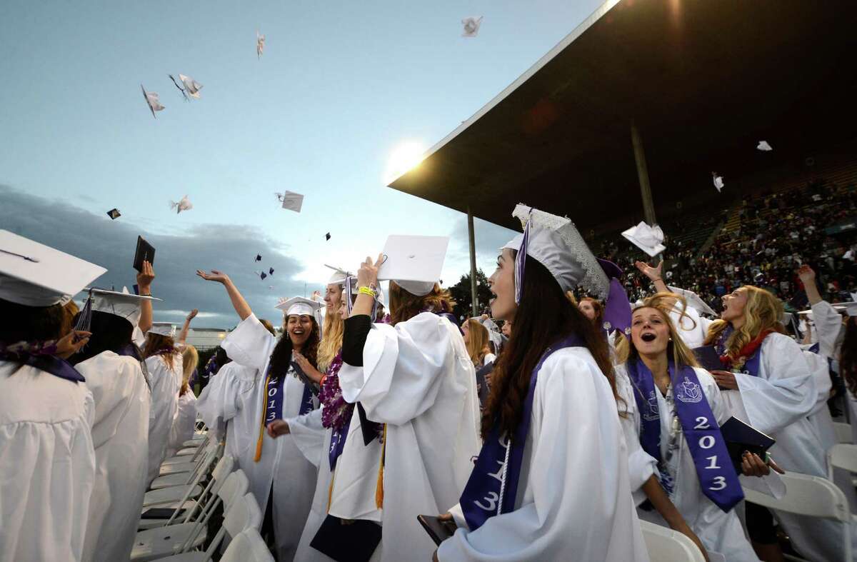 A few students throw up their caps after the traditional turning of the tassels during the James A. Garfield High School commencement ceremony at Memorial Stadium on Tuesday, June 11, 2013. Nearly 400 students graduated in the high school's 128th graduation ceremony.