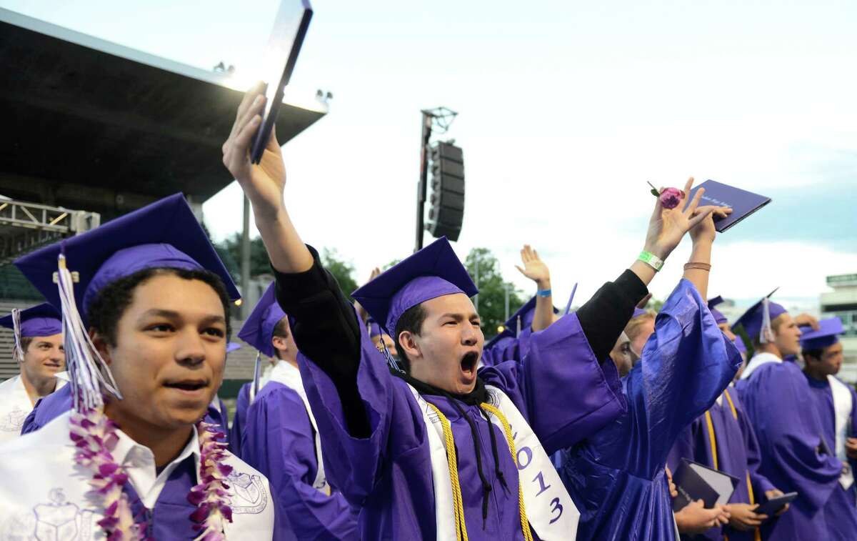 Students celebrate during the presentation of the class during the James A. Garfield High School commencement ceremony at Memorial Stadium on Tuesday, June 11, 2013. Nearly 400 students graduated in the high school's 128th graduation ceremony.