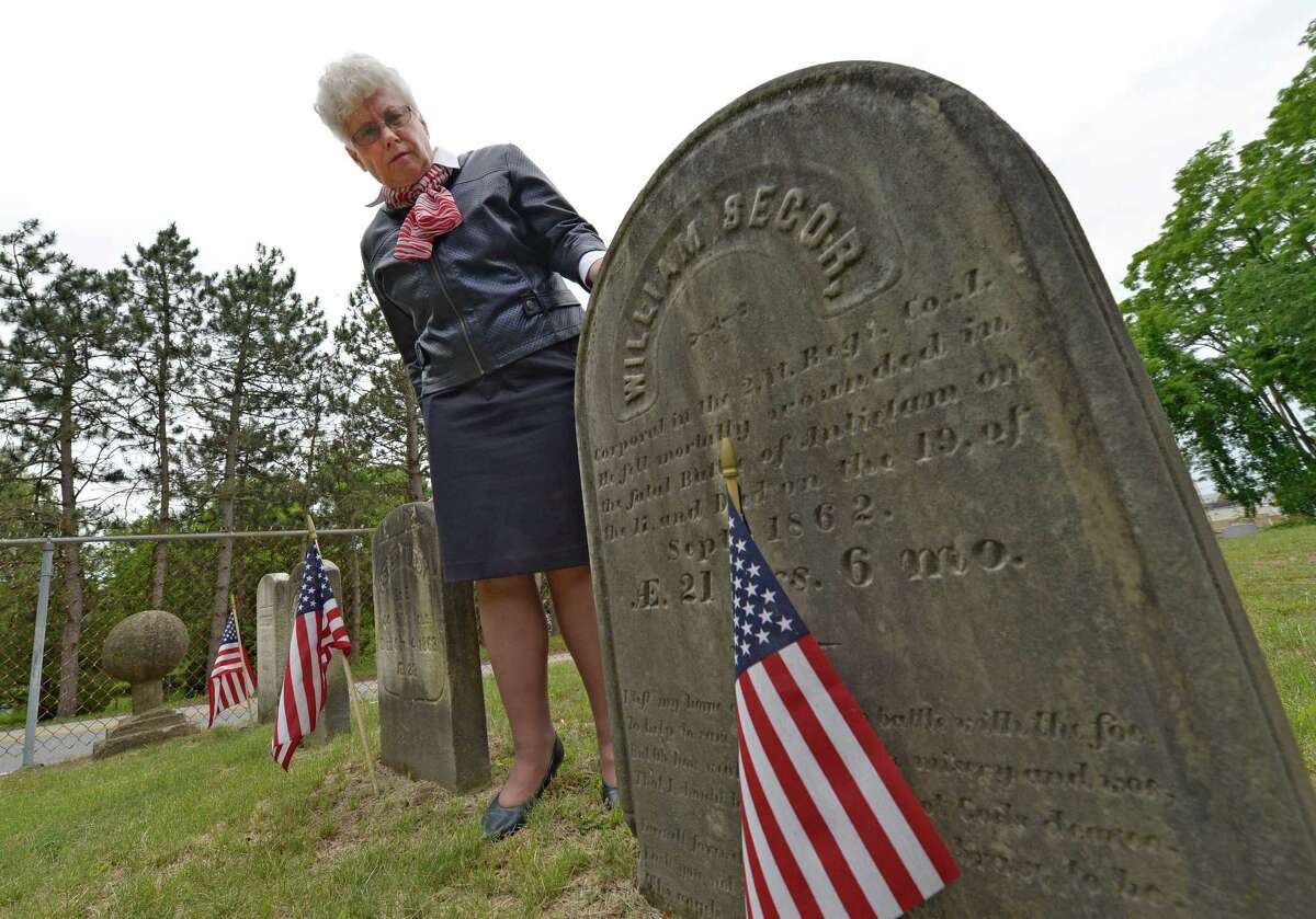 Nancy Morris looks over the grave stone, June 10, 2013, of Civil War soldier William H. Secor, a Halfmoon resident who died in the Battle of Antietam and who is buried in the Clifton Park Cemetery in Halfmoon, N.Y. (Skip Dickstein/Times Union)