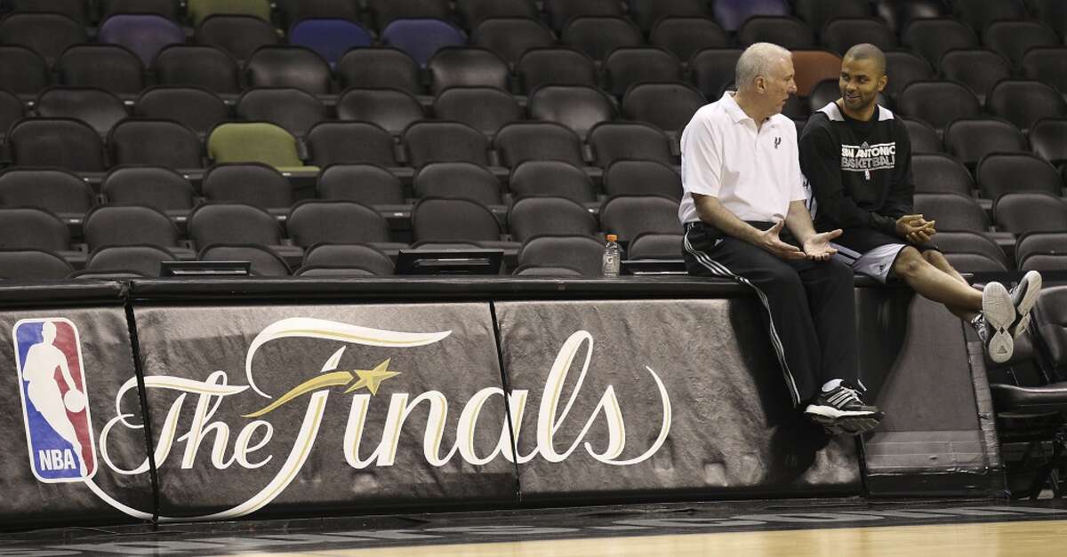 Coach Gregg Popovich (left) and Tony Parker chat during practice and media sessions at the AT&T Center on Wednesday, June 12, 2013.