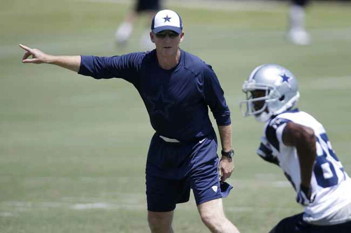Dallas Cowboys head coach Jason Garrett instructs wide receiver Jared Green (85) during workouts at an NFL football minicamp practice Tuesday, June 11, 2013, in Irving, Texas. (AP Photo/Tony Gutierrez)