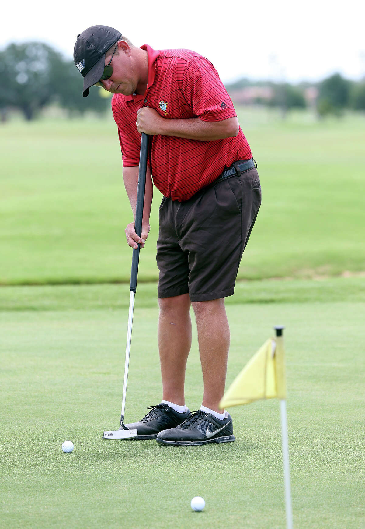 Adam Lowe practices with his long putter before teeing off for a round of golf at the Alsatian Golf Club in Castroville on June 12, 2013.