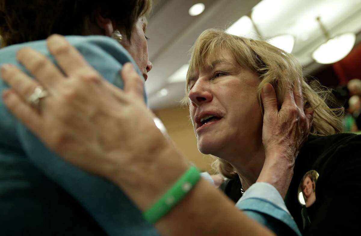 WASHINGTON, DC - JUNE 13: Teresa Rousseau (R), the mother of school teacher Lauren Rousseau who was killed during the Sandy Hook Elementary School shooting, is hugged by House Minority Leader Nancy Pelosi (D-CA) (L) durina an event marking the six month anniversary of the Newtown, Connecticut shooting at the U.S. Capitol June 13, 2013 in Washington, DC. Friends and family members of the shooting victims joined members of Congress for a day long event to honor the 26 children and educators killed in the December shooting, and to renew calls for gun reform legislation.