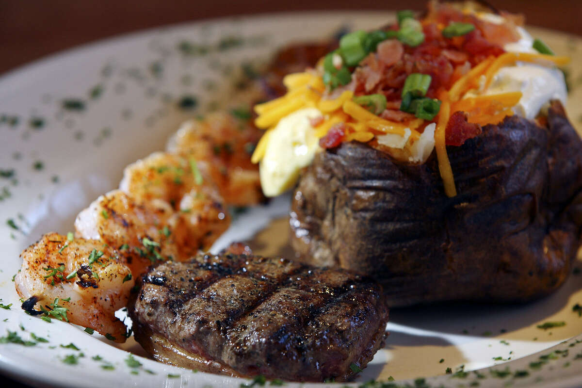A bacon-wrapped fillet, grilled shrimp kebab and loaded baked potato delight diners at 54th Street Grill & Bar.