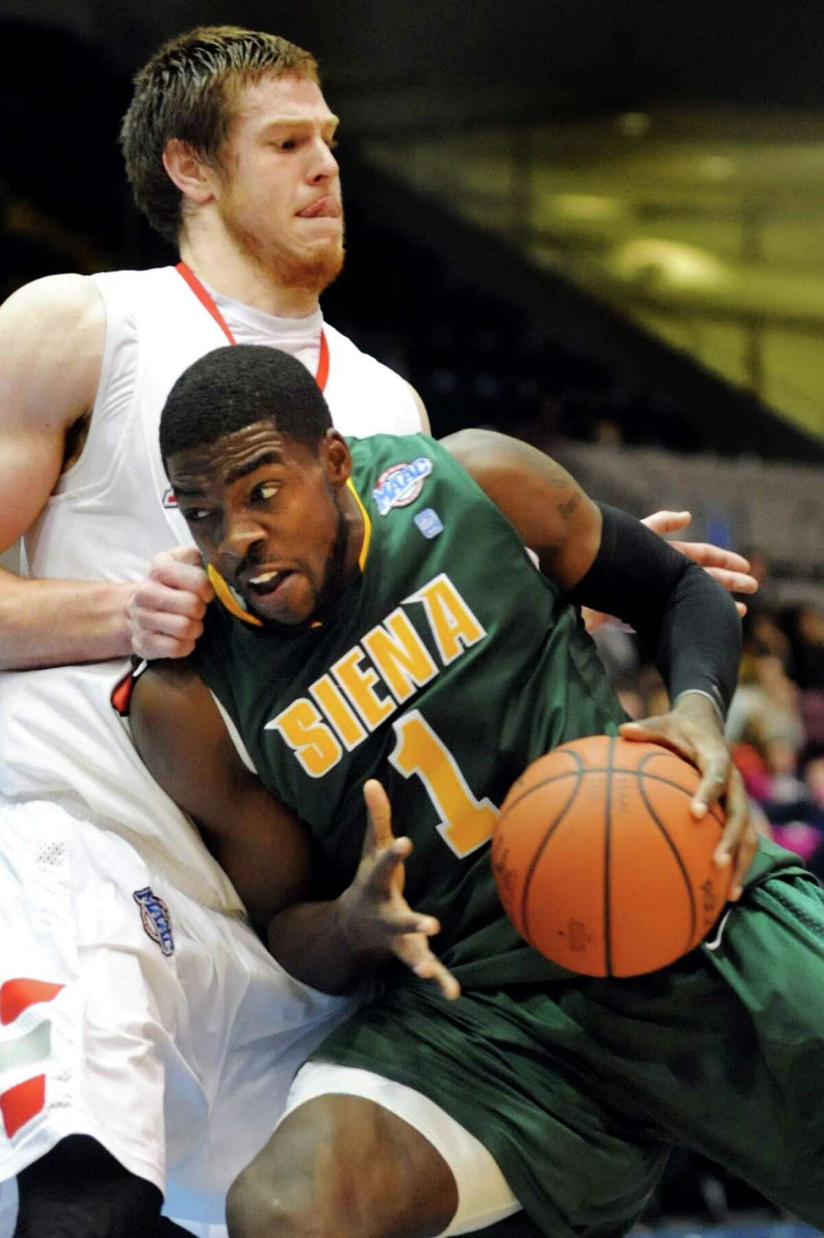 Siena's O.D. Anosike (1), right, tries to get past Marist's Adam Kemp (50) during their first round MAAC Championship basketball game on Friday, March 8, 2013, at MassMutual Center in Springfield, Mass. (Cindy Schultz / Times Union)
