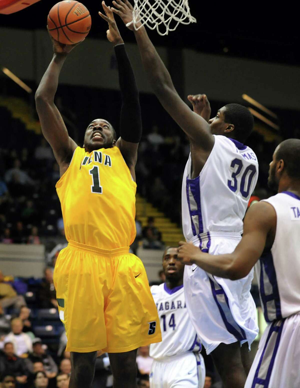 Siena's O.D. Anosike (1), left, shoots for two points as Niagara's Joe Thomas (30) defends in their quarterfinal MAAC Championship basketball game on Saturday, March 9, 2013, at MassMutual Center in Springfield, Mass. (Cindy Schultz / Times Union)