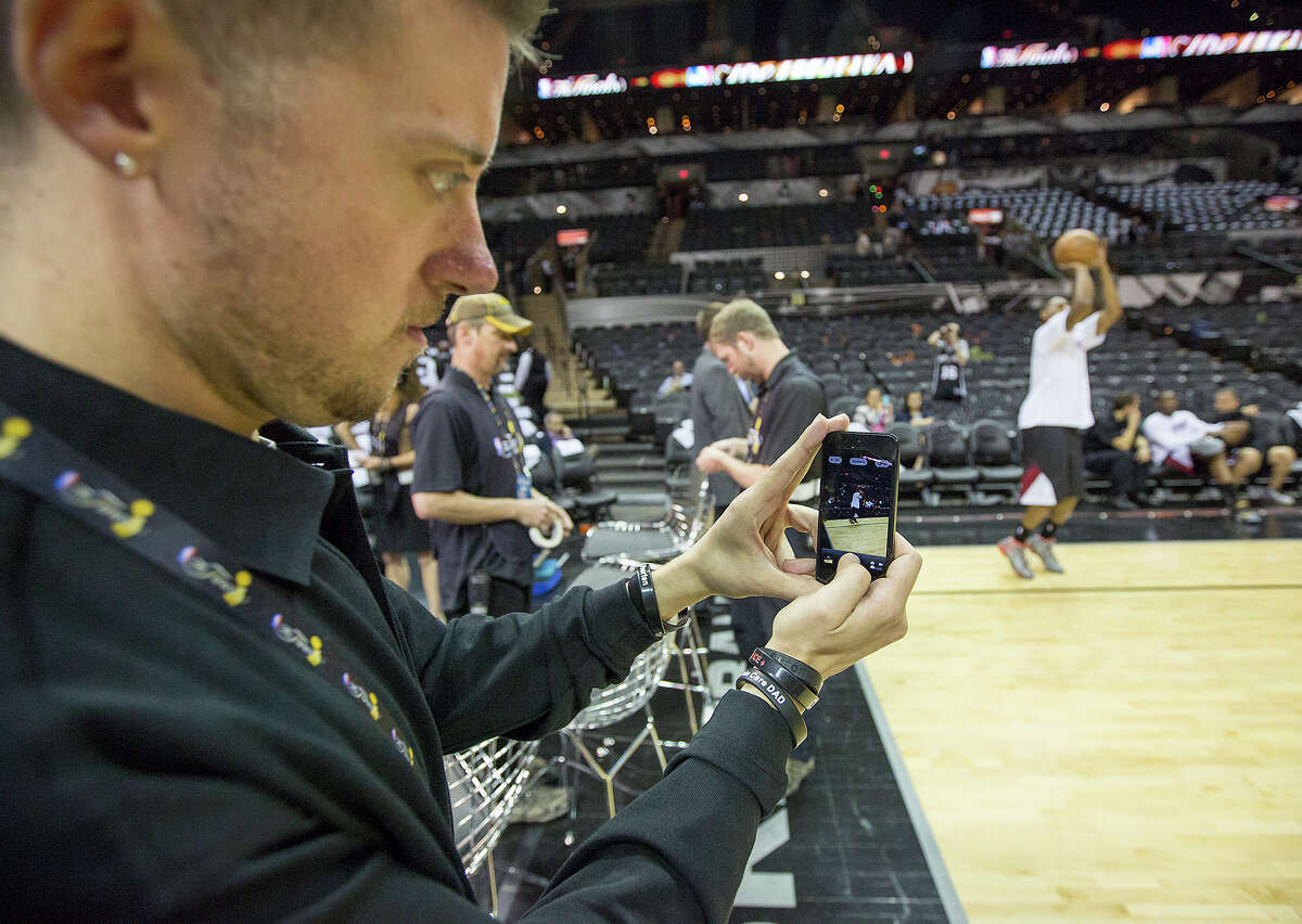 FOR BUSINESS - Jim Poorten, senior specialist of social media at the NBA, takes a photo of the pregame between the San Antonio Spurs and the Miami Heat at the AT&T Center on Thursday, June 13, 2013. MICHAEL MILLER / FOR THE EXPRESS-NEWS