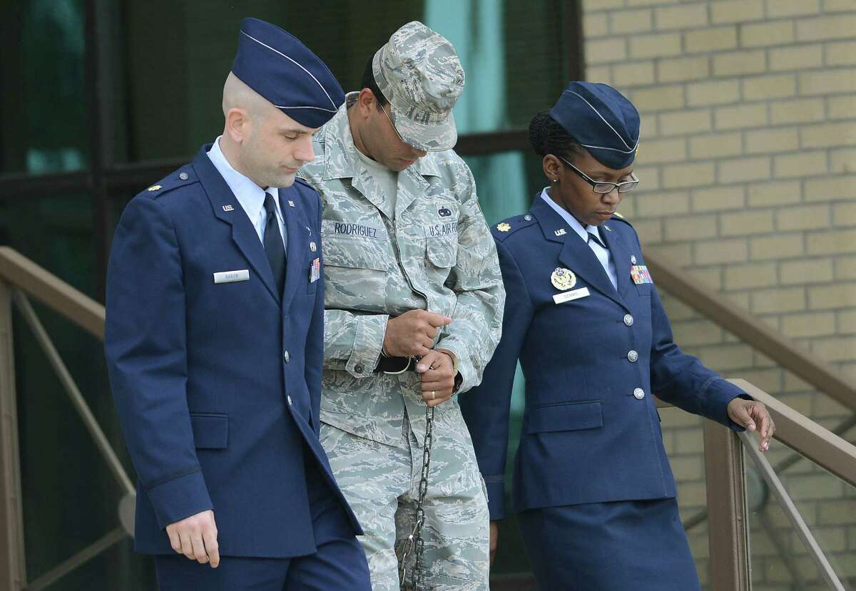 Air Force Tech Sergeant Jaime Rodriguez, middle, exits the court at Lackland Air Force Base where he was sentenced for sex crimes on Friday, June 14, 2013.