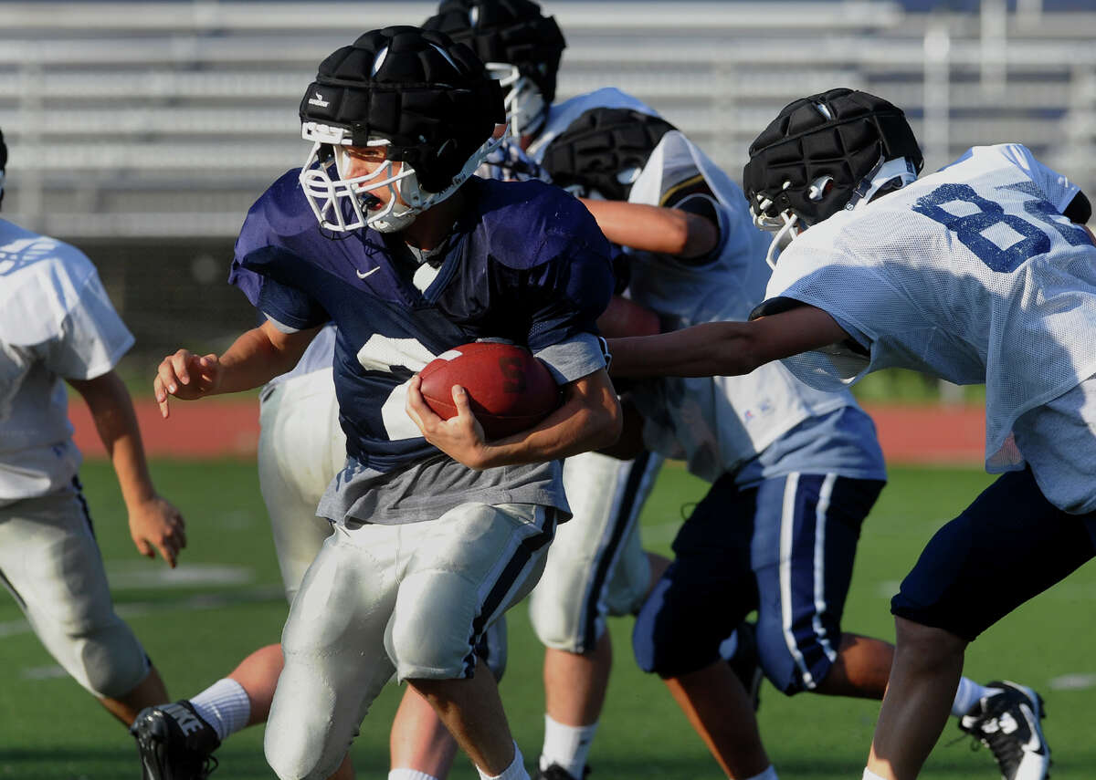 Staples' Jack Griffin carries the ball, during spring football game action at Staples in Westport, Conn. on Friday June 14, 2013.