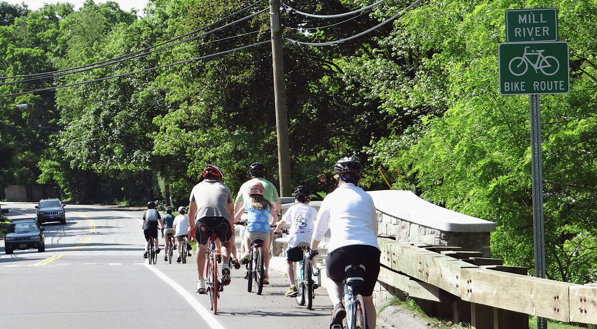 Bicyclists take an inaugural ride on the the new Mill Plain Road bike/walk route after its dedication Saturday morning.