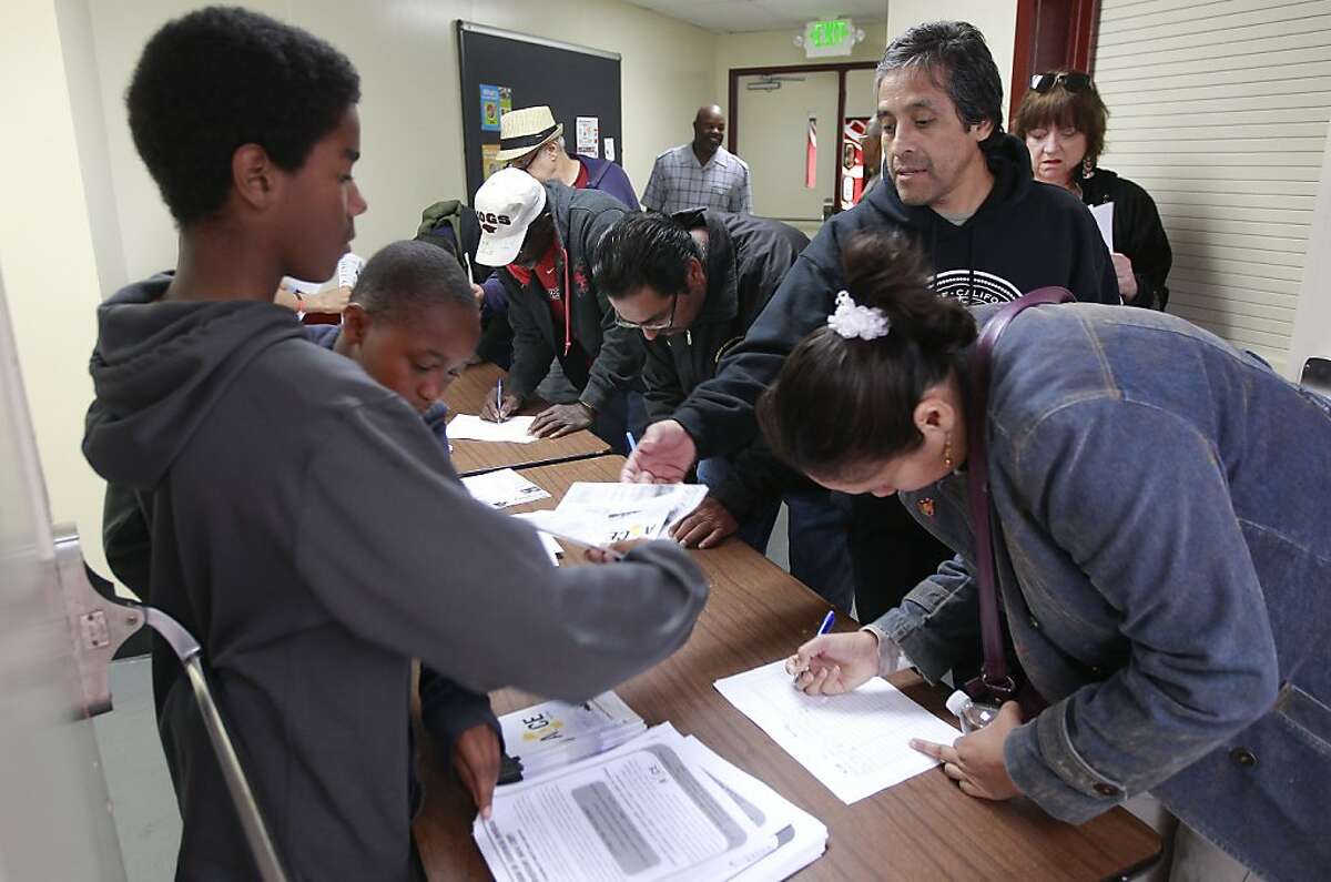 Citizens sign in for the public meeting in Richmond, Calif. on Saturday June 15, 2013, at the Nevin Community Center to inform the public how the plan would work. A radical new program is being proposed as a way to help struggling homeowners that could lead the city to use eminent domain to seize underwater mortgages and restructure them to keep families in their homes.