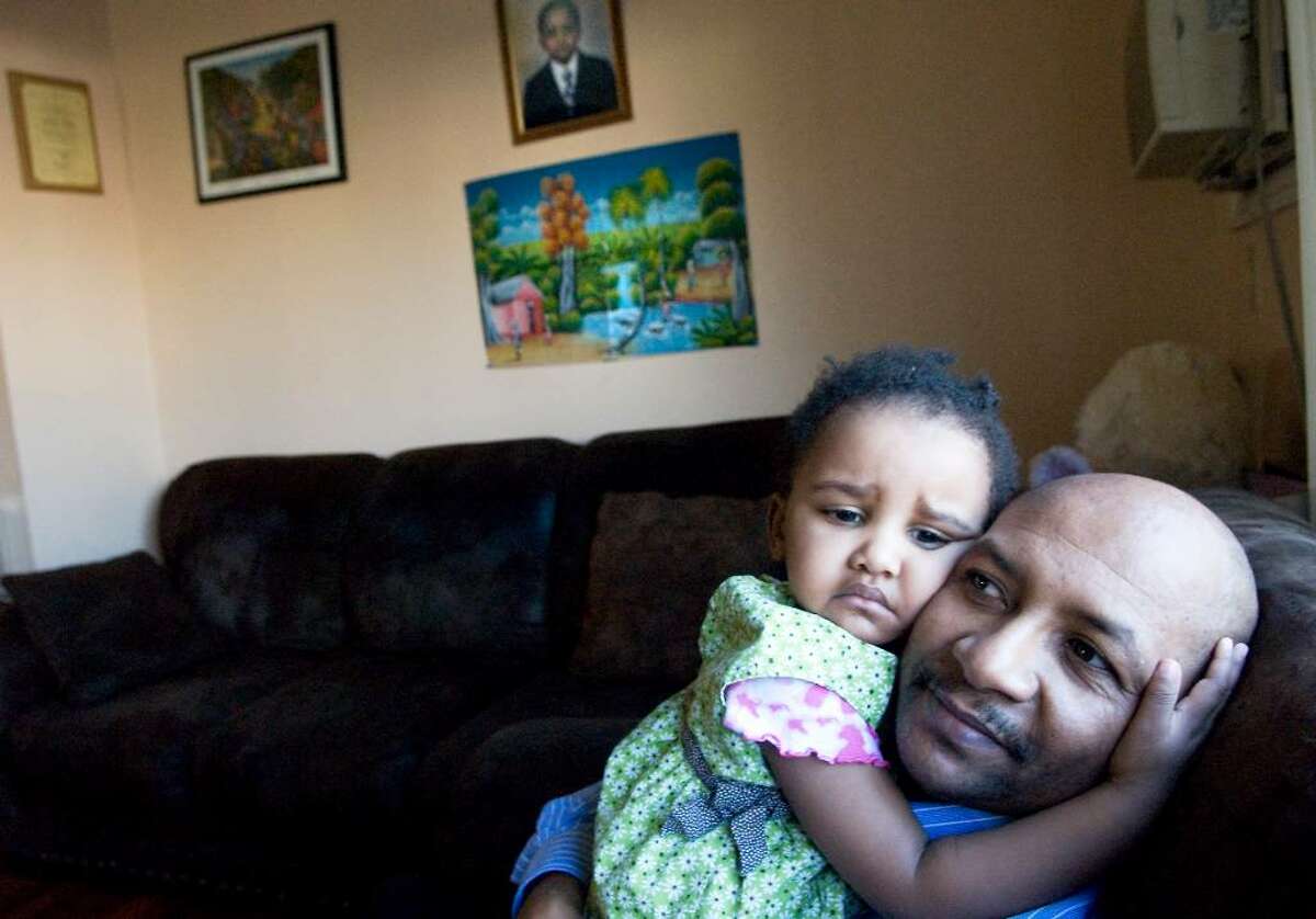 Emmanuel Doreste and his daughter Ayanna Doreste, 2, in their Stamford home. Doreste is originally from Haiti and is waiting to hear from several family members who either live or were visiting the area of the earthquake.