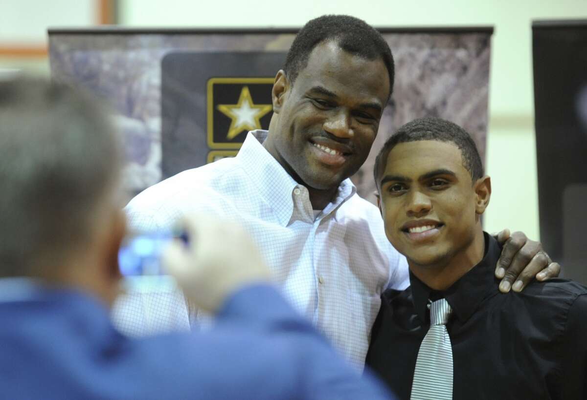 Father David Robinson and son pose for a picture after Corey Robinson's selection to the U.S. Army All-American Bowl at San Antonio Christian High School on Nov. 30, 2012.