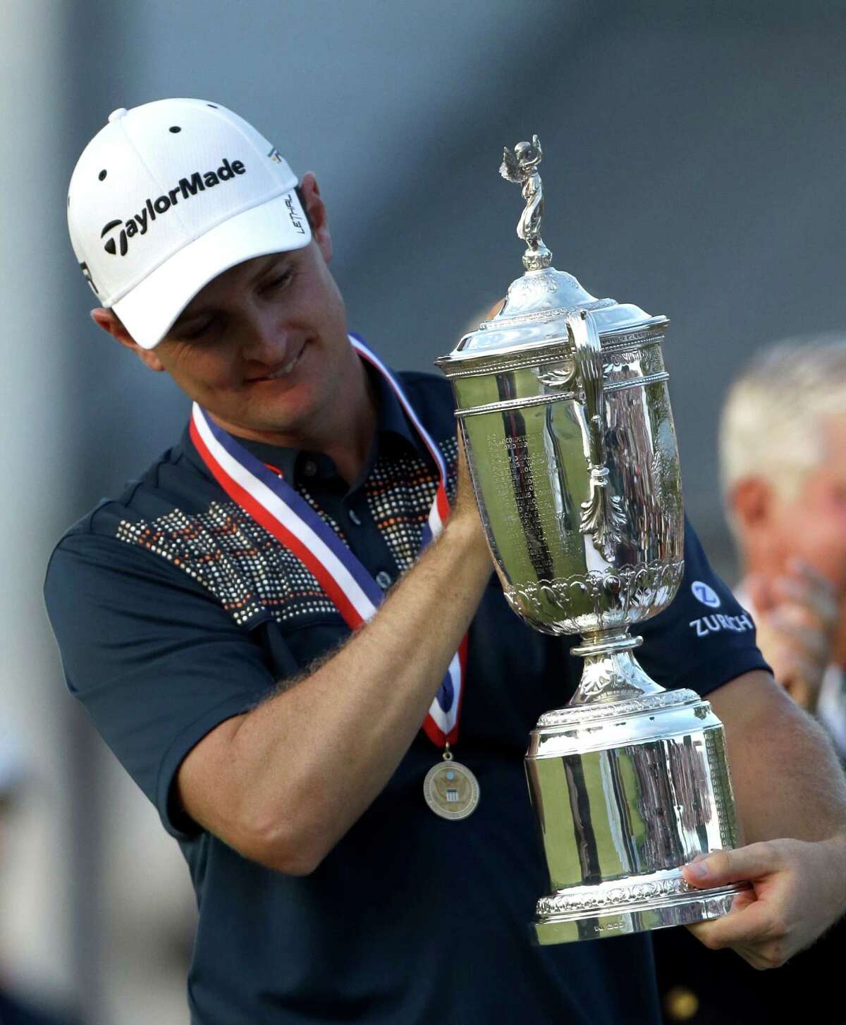 Justin Rose, of England, celebrates with the trophy after winning the U.S. Open golf tournament at Merion Golf Club, Sunday, June 16, 2013, in Ardmore, Pa. (AP Photo/Julio Cortez)