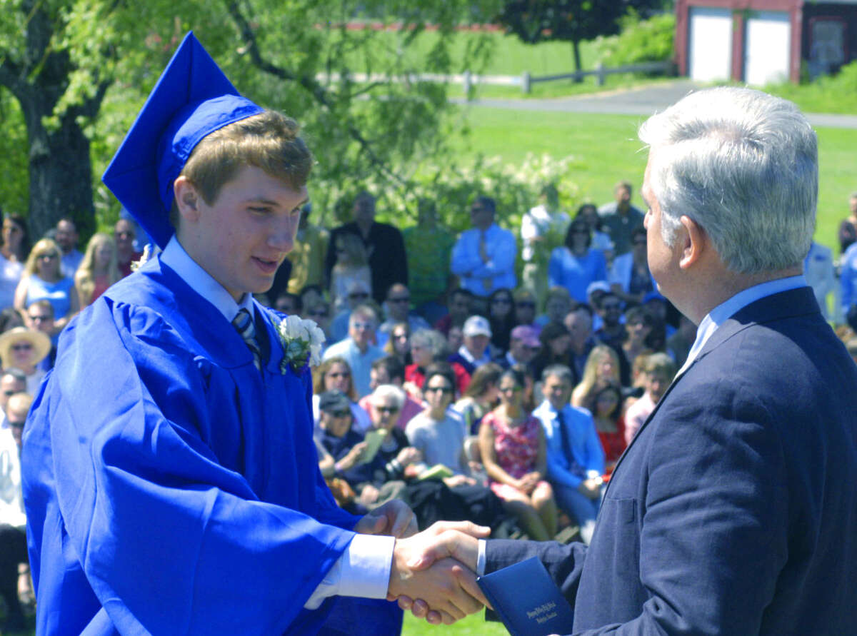 Tyler Leslie receives his diploma from Region 12 Board of Education chairman James Hirschfield during the Shepaug Valley High School's commencement ceremony for the Class of 2013. June 15, 2013