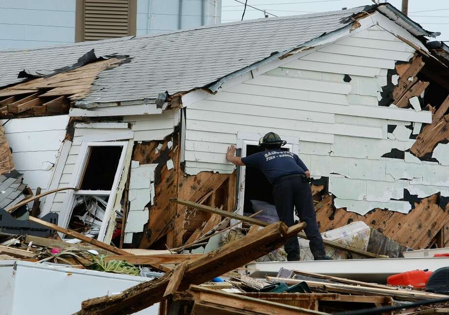 GALVESTON, TX - SEPTEMBER 14: Galveston fire fighter Martin Moses inspects damaged homes September 14, 2008 in Galveston, Texas. Hurricane Ike made landfall yesterday morning at Galveston causing widespread wind and flood damage along the Texas and Louisiana coasts. (Photo by Mark Wilson/Getty Images)