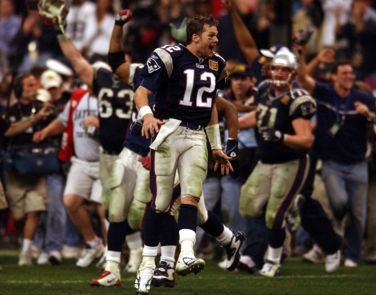 Patriots quarterback - and Super Bowl MVP - Tom Brady (12) joins his teammates in celebrating their victory.