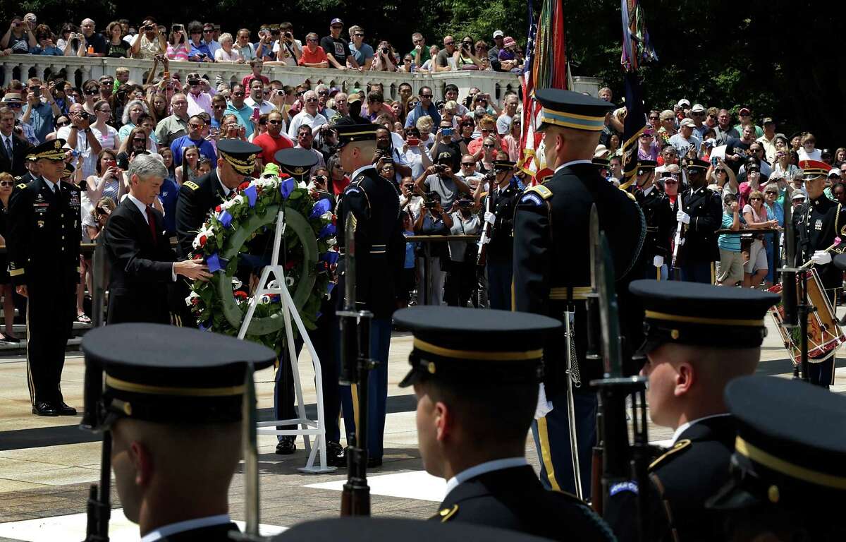 U.S. Secretary of the Army John McHugh (left) joins members of the U.S. Army's Old Guard at Arlington National Cemetery as part of the Army's celebration of its 238th birthday. A campaign has been launched in support of construction of a national Army museum.