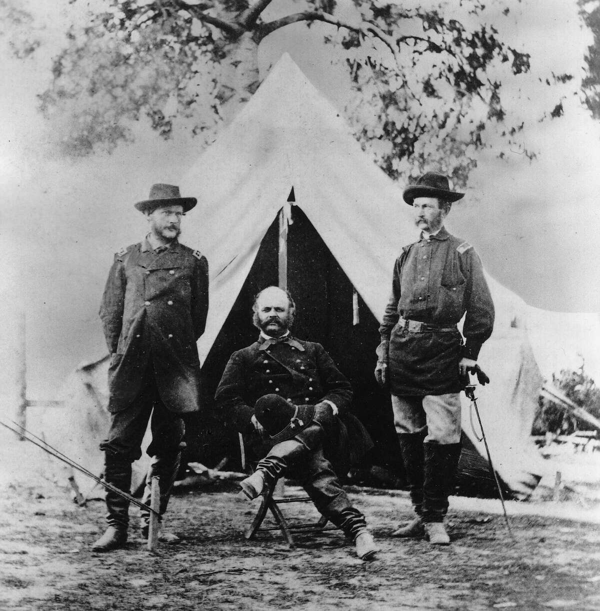 Maj. Gen. A.E. Burnside sits between two staff members near Richmond, Va., in this Civil War photo by Alexander Gardner.