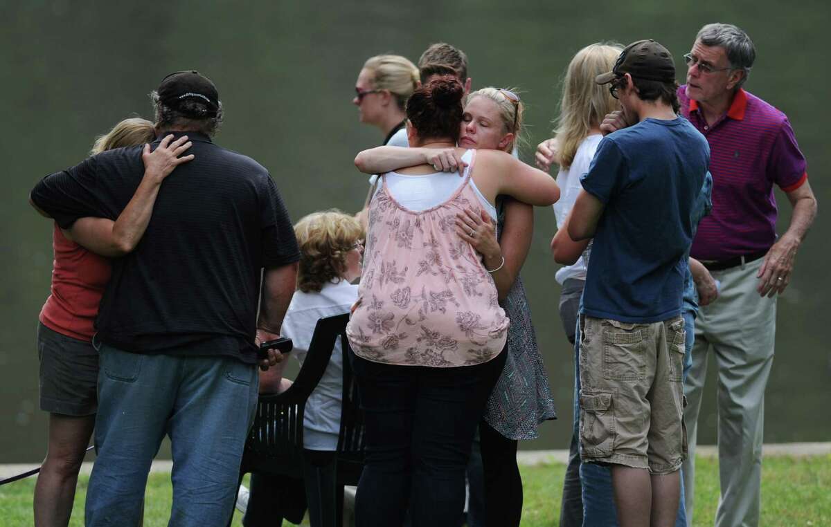 Friends and family of missing New Milford photographer Eric Langlois grieve by Lake Lillinonah in Bridgewater, Conn. on Tuesday, June 18, 2013. A body, which has not yet been identified, was found near where Langlois went missing at Lover's Leap State Park last week.