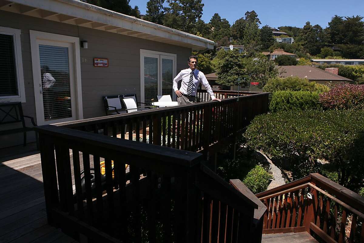 Real estate attorney Jeff Lerman stands at the entry to one of the duplex units he bought a few months ago in Tiburon, Calif., as rental property on Monday, June 17, 2013. Jeff bought it from a flipper who remodeled the duplex without city permits and inspections. Lerman replaced and fully remodeled both kitchens in compliance with the city of Tiburon, bringing electric and plumbing up to code.