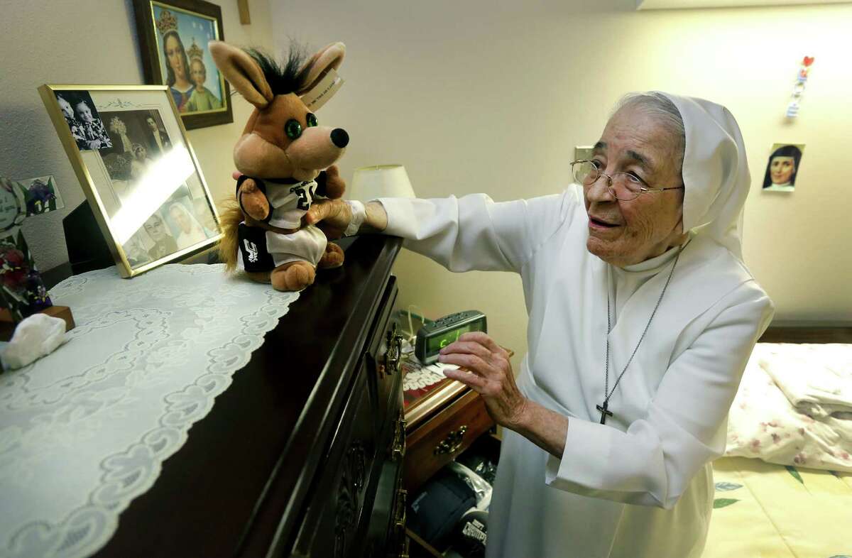 Sister Rosalba Garcia places a dancing Coyote doll on her dresser in her room. The nuns from the Salesian Sisters love their Spurs and pray for them before and during games, on Wednesday, June 19, 2013.