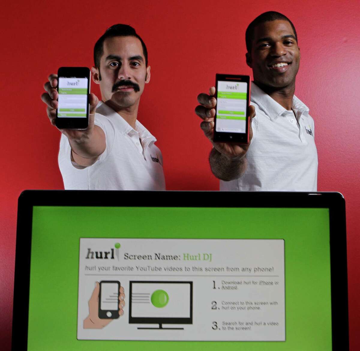 Naaman Esquivel, left, and Lawrence Johnson, right, founders of Hurl pose at the Houston Technology Center, 410 Pierce Street, Tuesday, Jan. 15, 2013, in Houston. Hurl is an app that lets users launch videos from their phone onto any screen that's wired to the internet. ( Melissa Phillip / Houston Chronicle )