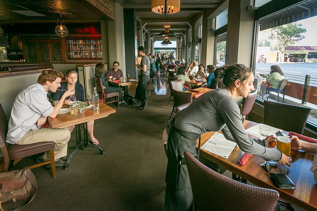 People enjoy dinner in the dining room at Tribune Tavern in Oakland, Calif., on Thursday, June 13th, 2013.