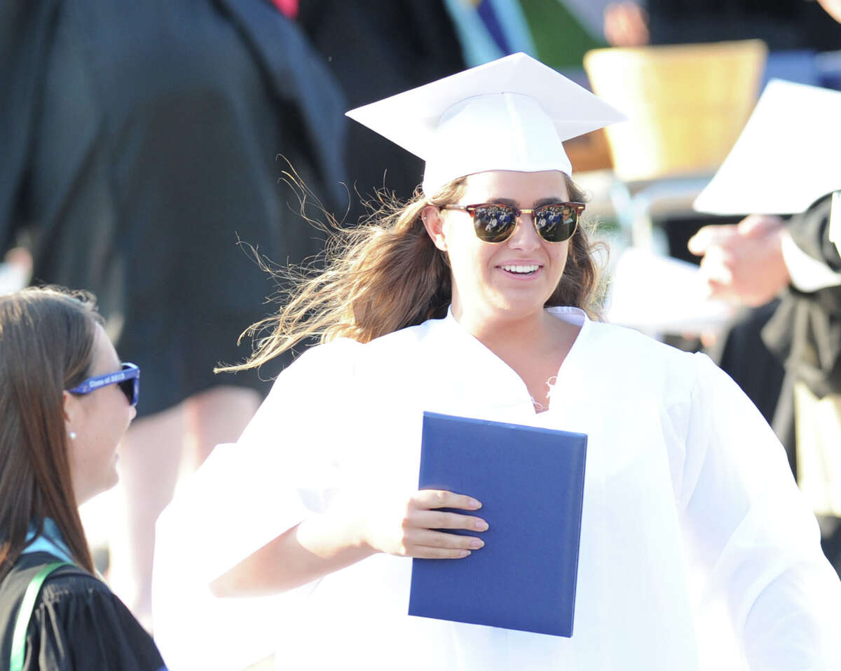 Caroline Macomber, 18, smiles after receiving her Darien High School diploma during the graduation ceremony on the athletic field at the school, Thursday evening, June 20, 2013. Macomber said she will be attending Gettysburg College in the fall.
