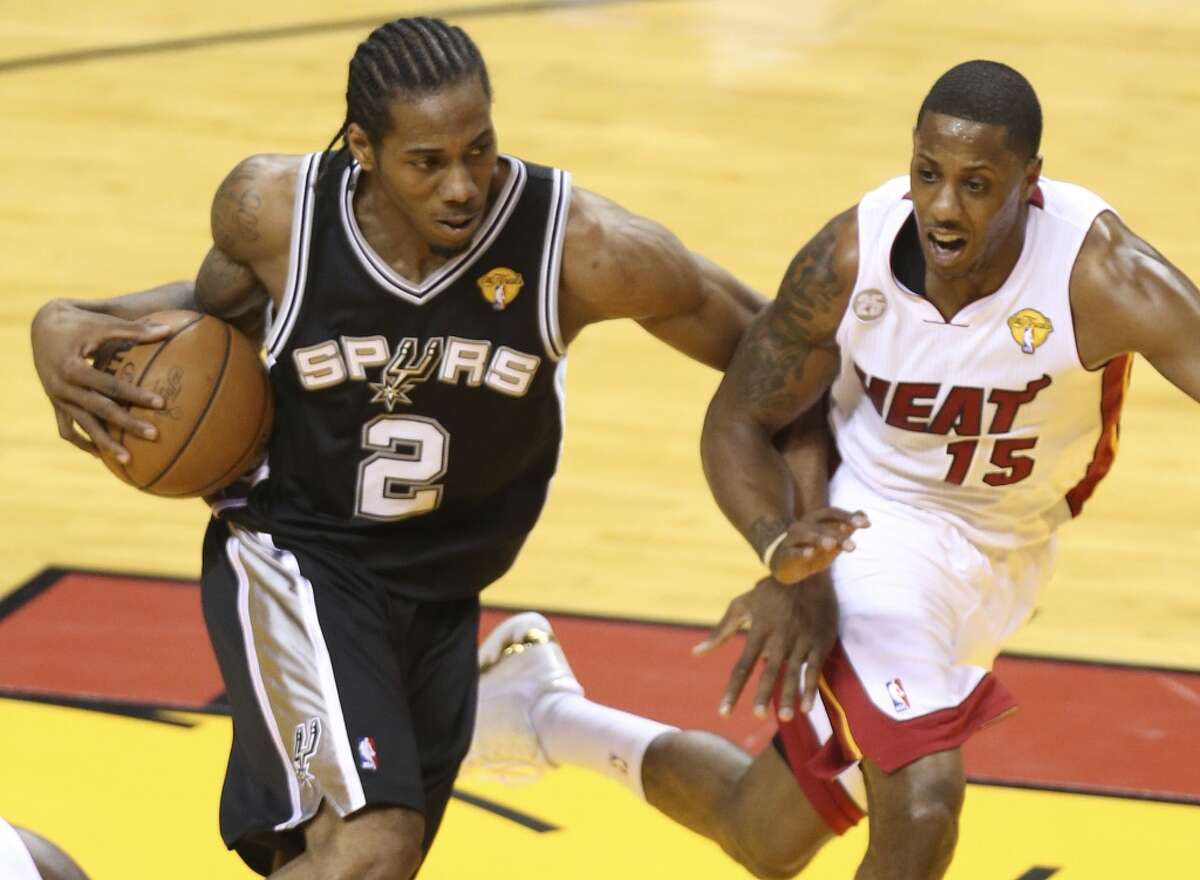 San Antonio Spurs' Kawhi Leonard tries to drives around Miami Heat's Mario Chalmers during the first half of Game 7 of the NBA Finals at American Airlines Arena on Thursday, June 20, 2013 in Miami. (Jerry Lara/San Antonio Express-News)