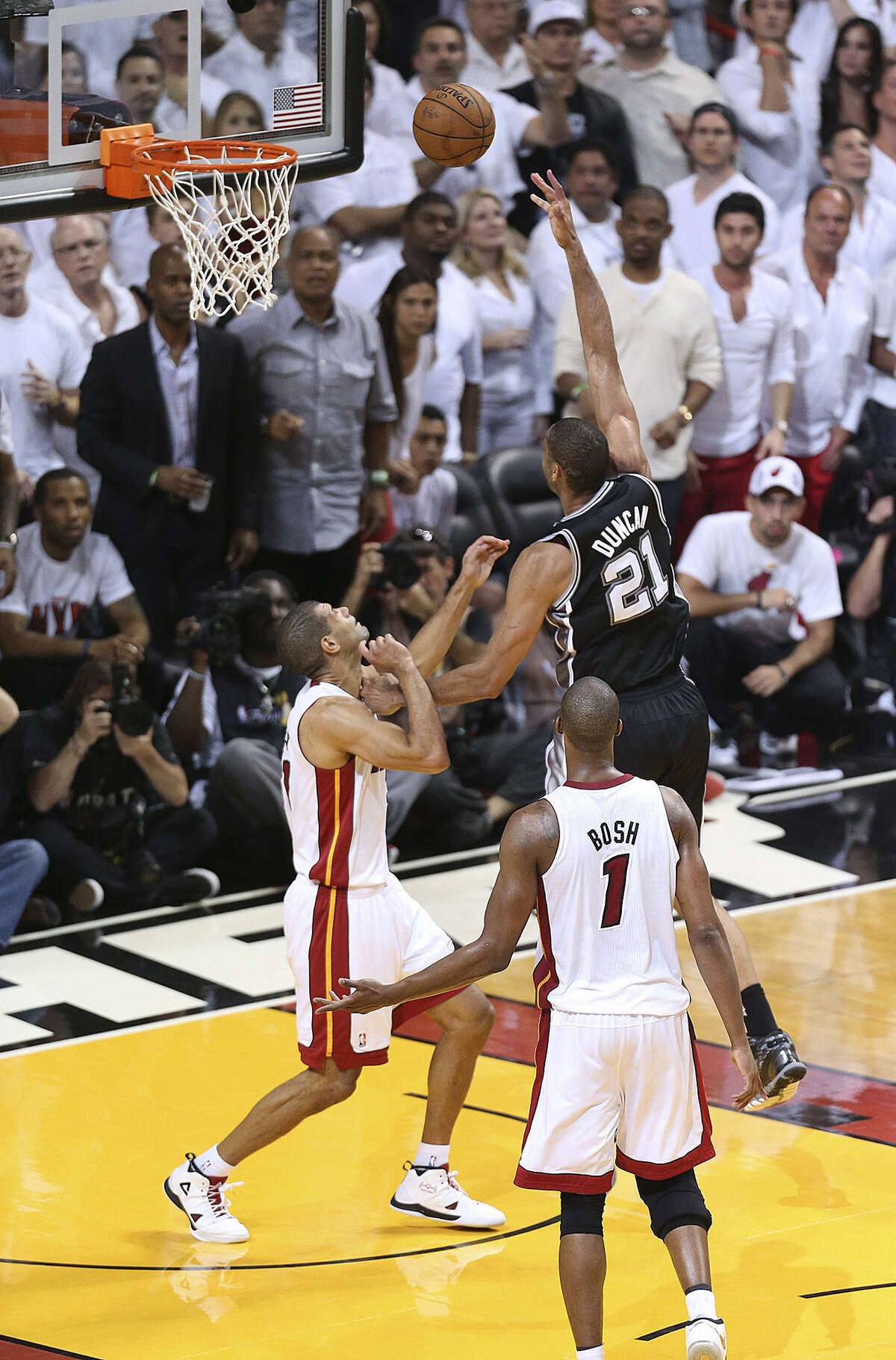 With the score 90-88, Tim Duncan misses a game-tying shot before missing a tip-in as Miami's Shane Battier defends.