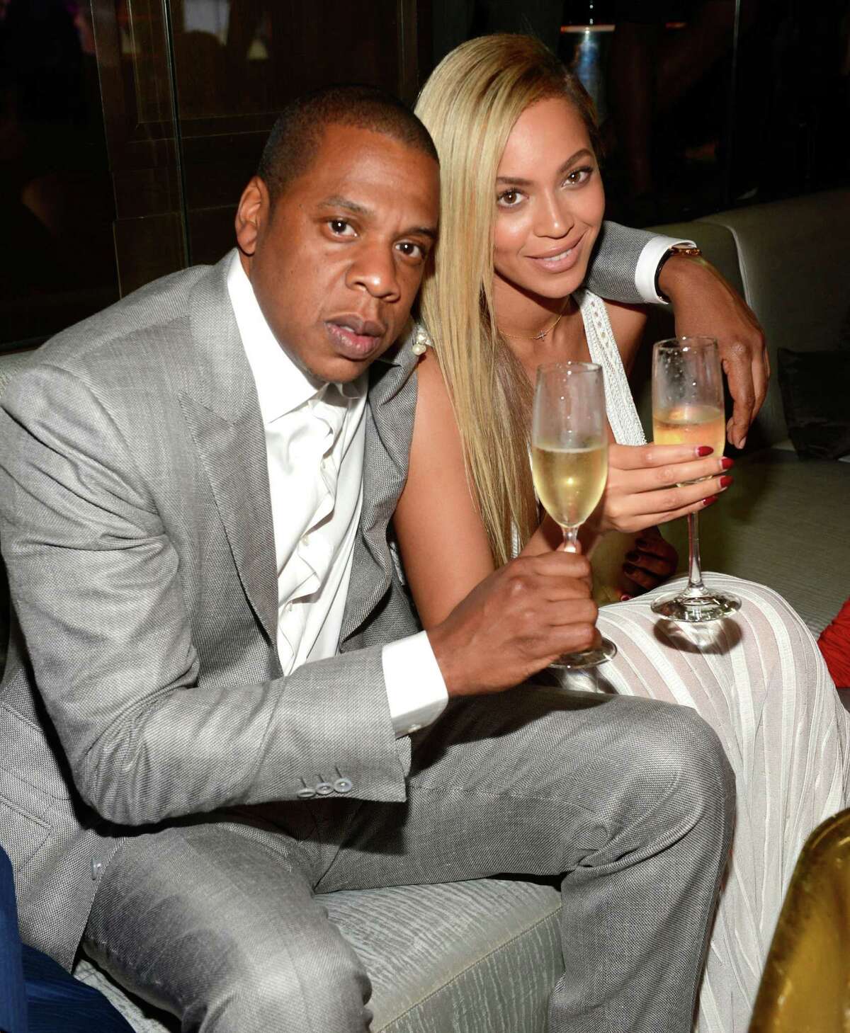 Jay-Z (sitting with Beyoncé) is expanding how he promotes his music through a deal with Samsung.