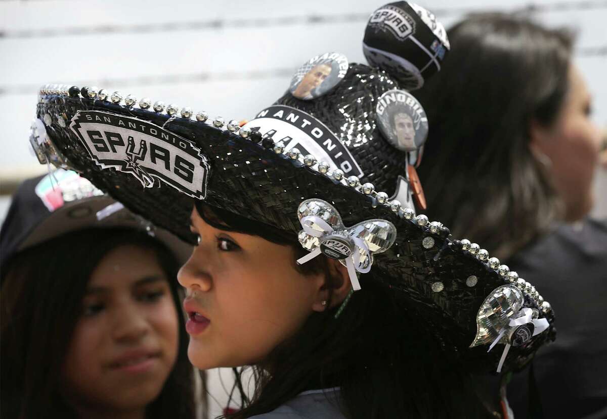 San Antonio Spurs fan Juliabell Castillon wears her Spurs sombrero as she waits for the team to arrive at the San Antonio International Airport on Friday, June, 21, 2013.