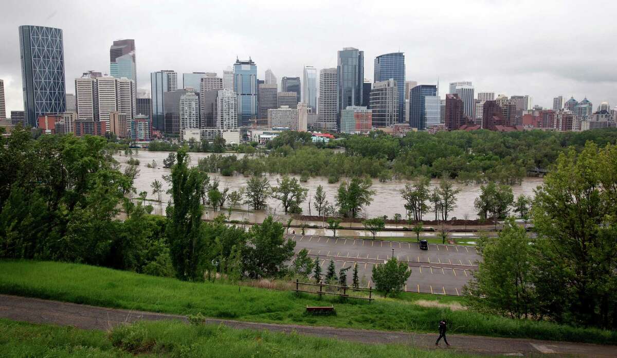 The Bow River overflows in Calgary, Canada on Friday, June 21, 2013. Heavy rains have caused flooding, closed roads, and forced evacuations in Calgary. (AP Photo/The Canadian Press, Jeff McIntosh)