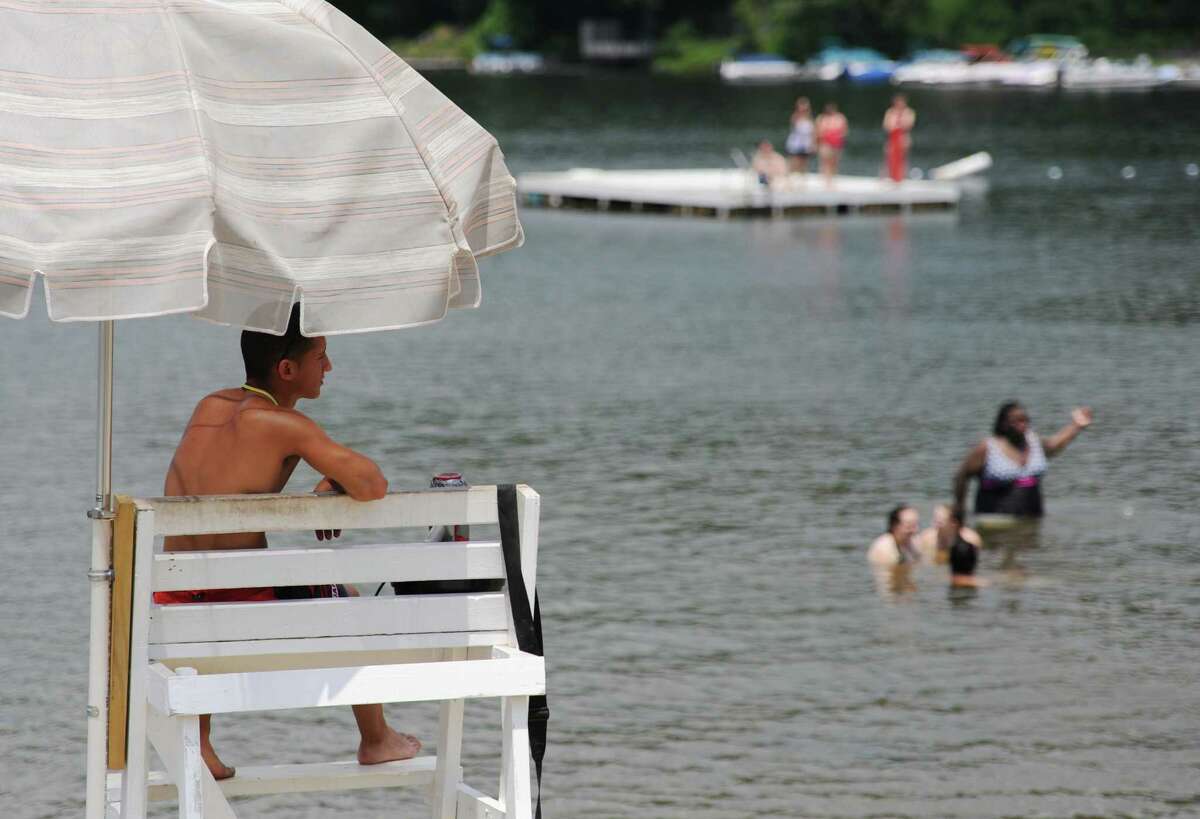 Lifeguard Shawn Silva keeps an eye on swimmers at Candlewood Park in Danbury, Conn. on the first day of summer, Friday, June 21, 2013. Over 200 students from Broadview Middle School came Friday to swim and enjoy the warm weather at the park.