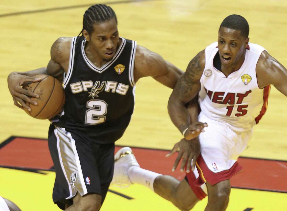 Spurs forward Kawhi Leonard, driving on the Heat's Mario Chalmers, averaged 14.6 points and 11.1 rebounds in the Finals.