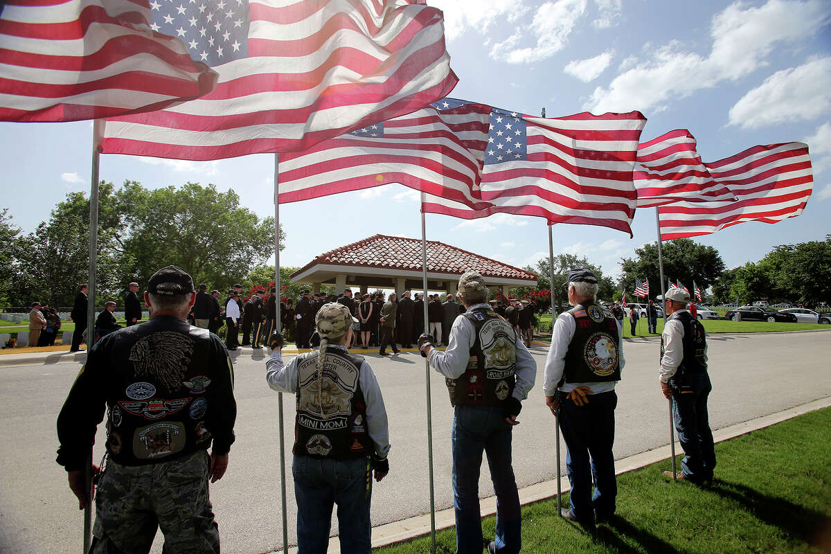 Flags are displayed as Lt. Col.Todd J. Clark is honored in burial services at Fort Sam Houston National Cemetery on June 21, 2013.