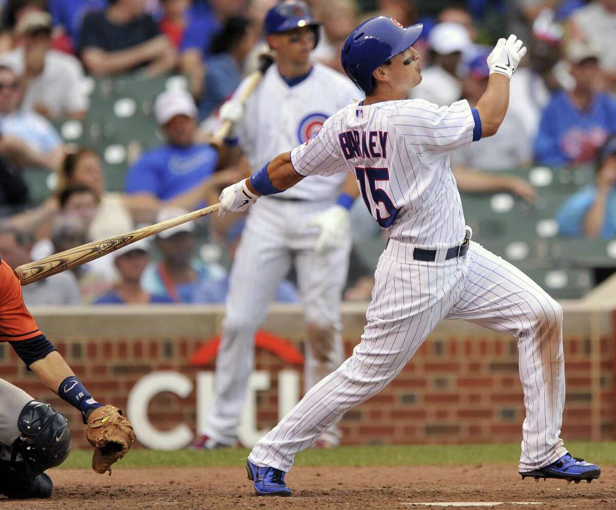 The Cubs' Darwin Barney connects on a homer in a game delayed by rain for more than three hours.