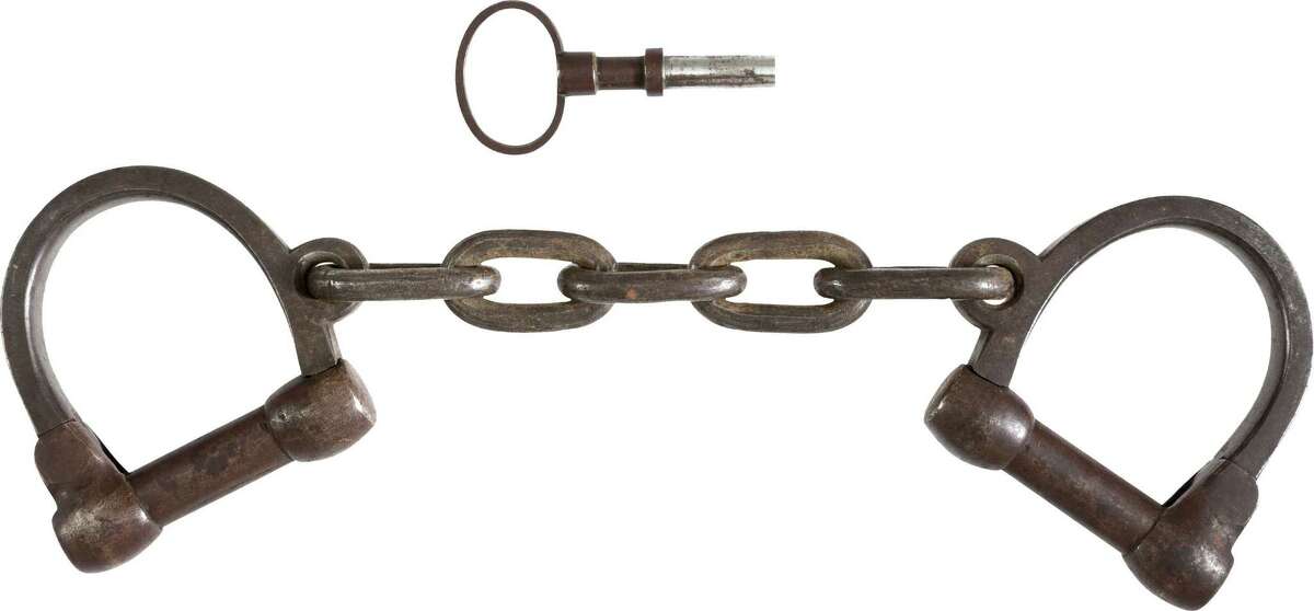 This June 17, 2013 provided by Heritage Auctions, shows the pair of leg irons, or shackles, believed to be those used on John Brown during his incarceration at the Charlestown, W.Va., jail following his arrest during the raid at Harper's Ferry W.Va. John Brown's capture of the Federal Arsenal at Harper's Ferry on Oct. 17, 1859 as part of a failed attempt to incite a slave uprising is seen by most historians as the spark that ignited the Civil War. They have been passed down in the family of John Boling, of Idaho, for six generations, after being obtained by a decedent shortly after Brown’s execution. They are expected to bring more than $10,000 when they come up for auction on June 22, 2013. (AP Photo/Heritage Auctions)