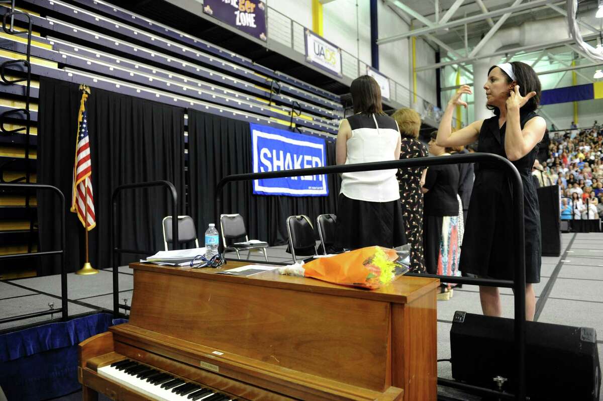 Sign language interpreter Liz Beauregard signs the national anthem during Shaker High Schools graduation commencement at the SEFCU Arena on Saturday June 22, 2013 in Albany, N.Y. (Michael P. Farrell/Times Union)