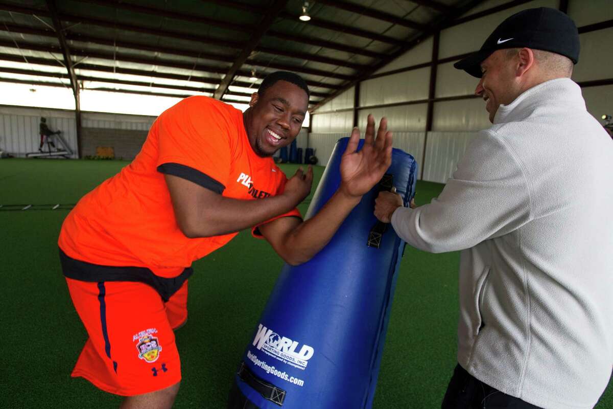 Former Auburn defensive lineman and Lombardi Award winner Nick Fairley, left, has been one of many top athletes to come to Danny Arnold for training