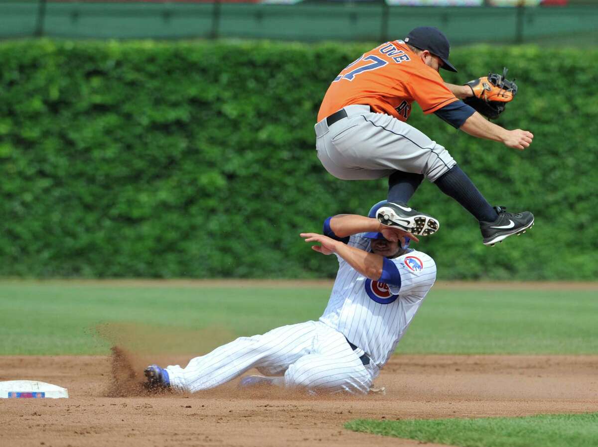 The Cubs' Welington Castillo tries to protect himself from a leaping Jose Altuve as he slides in safely at second base on a fielder's choice after a throwing error by Astros third baseman Matt Dominguez in the third inning Saturday.