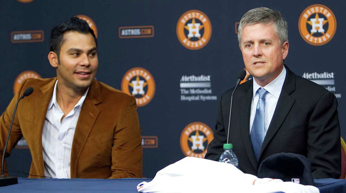 Carlos Pena left, looks on as Houston Astros General Manager Jeff Luhnow speaks during a press conference announcing Pena's signing of a one-year contract with the Houston Astros at Minute Maid Park Monday, Dec. 17, 2012, in Houston. ( James Nielsen / Chronicle )