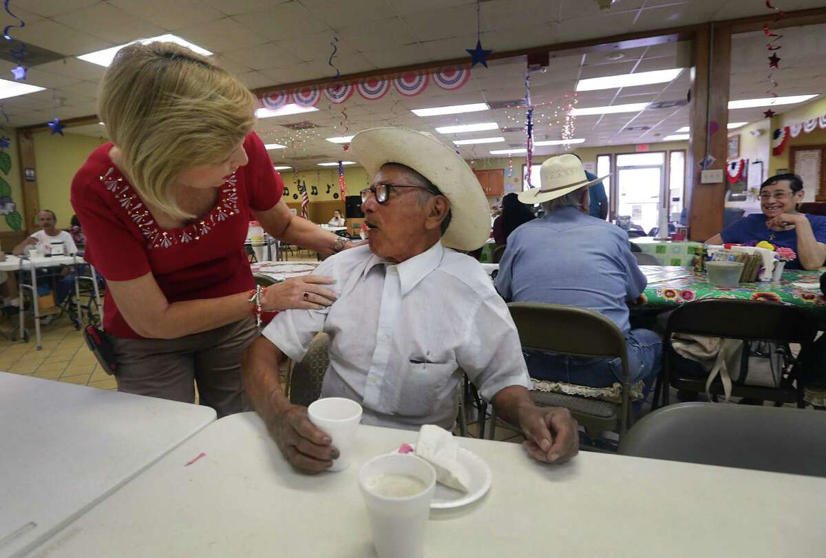 Sara Garza, owner of the Home Away From Home adult day care center in Penitas, chats with Medicaid managed care client Panchito Tovar, 81.