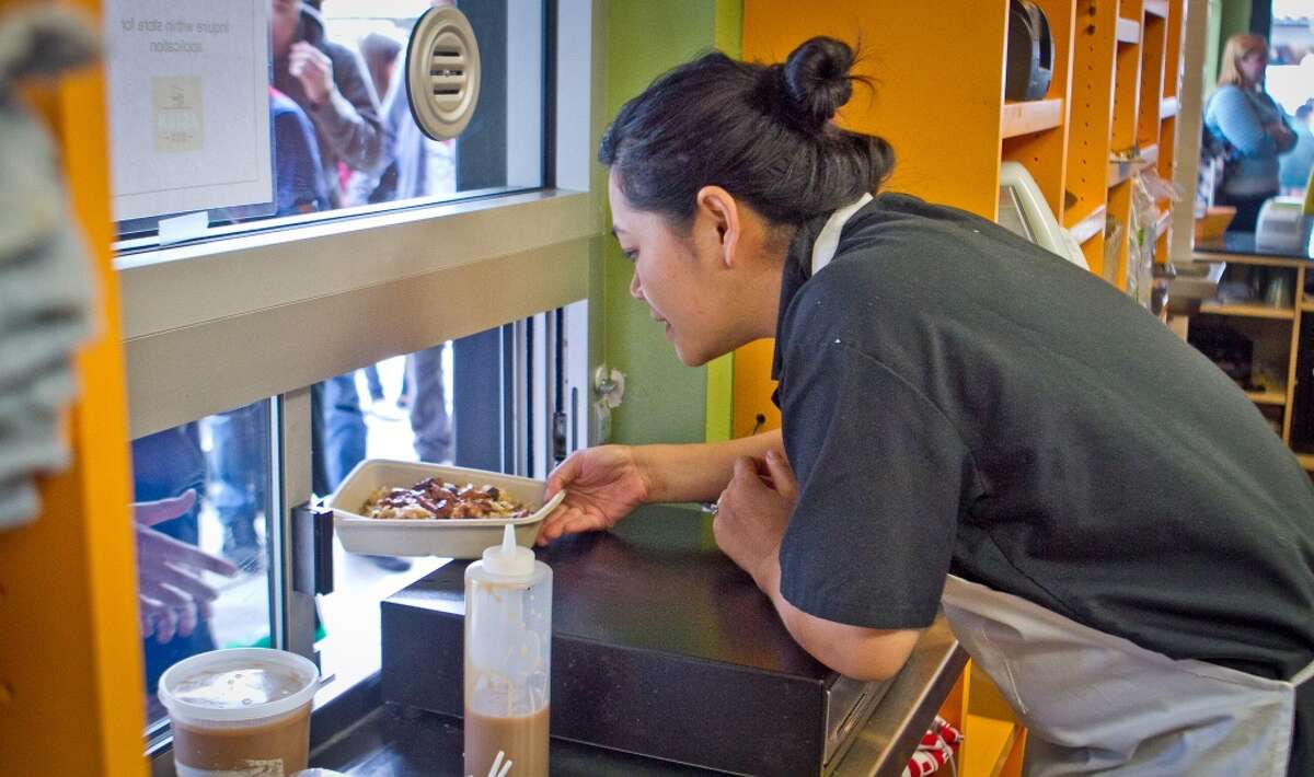Chef Grace Nguyen hands out boxes for lunch for students from Palo Alto High School at Asian Box in Palo Alto.